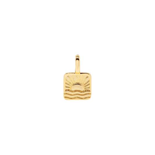 Gold square charm featuring an engraved sunrise and wave design on a white background.