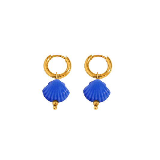 Bold blue seashell drop earrings with gold huggie hoops, perfect for beach-inspired looks.