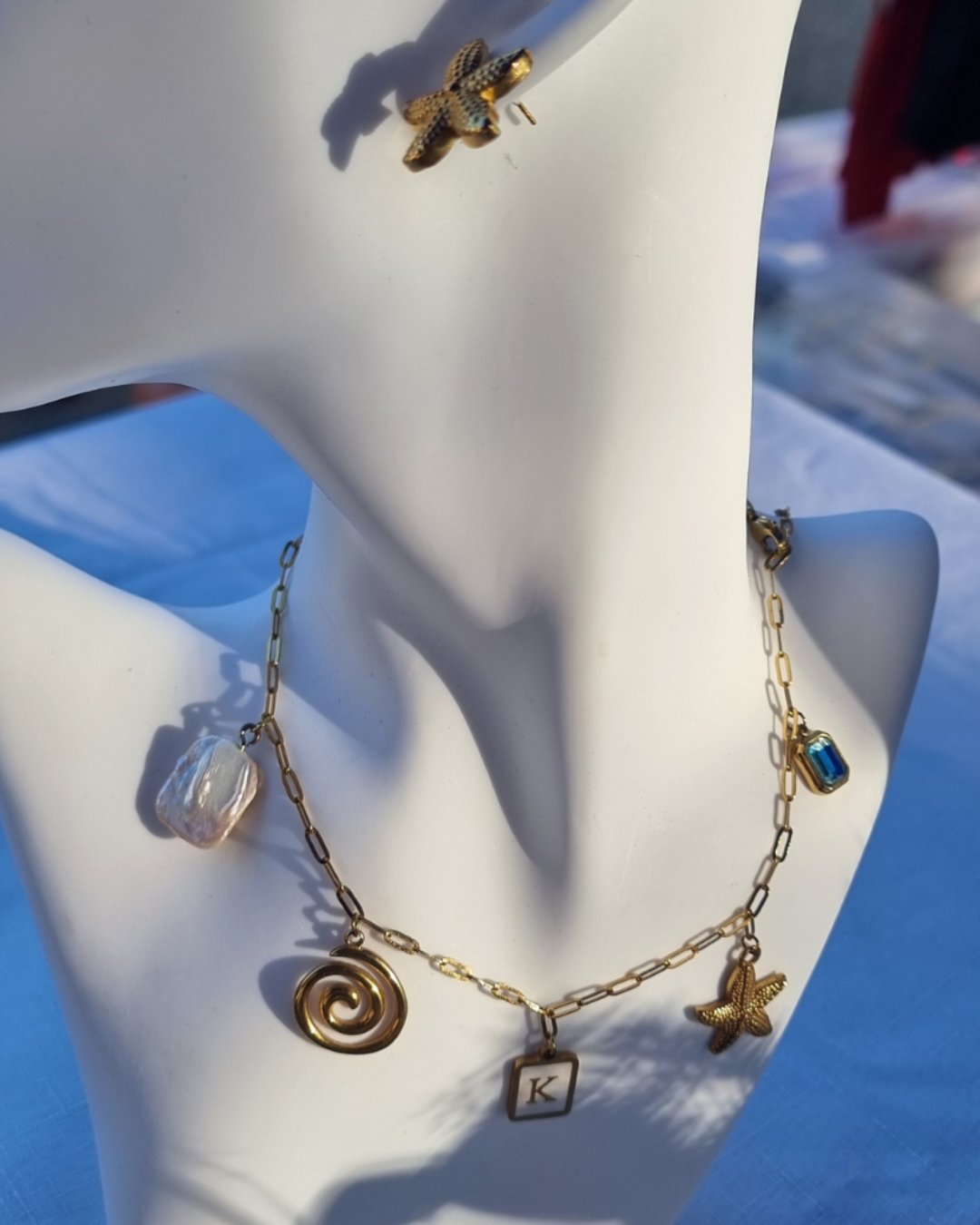 Custom necklace with gold charms, personalised initials, ocean-inspired designs, and birthstone — waterproof and 18k gold plated