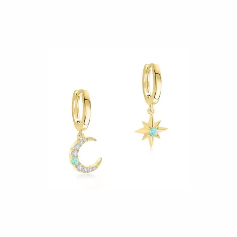 Celestial gold huggie earrings with mismatched moon and star charms, pavé detail and teal gemstone accent