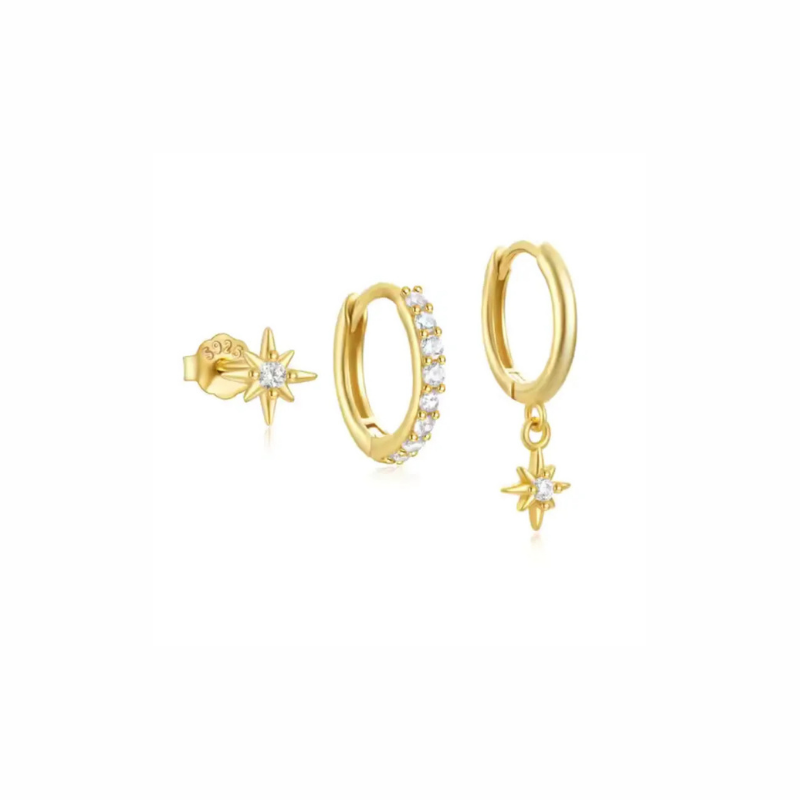 Dune gold earring set with pavé huggie, smooth huggie with star charm, and tiny north star stud
