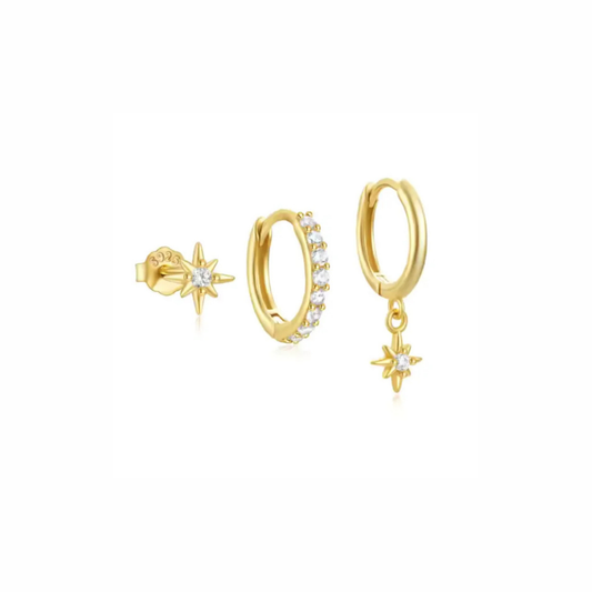Dune gold earring set with pavé huggie, smooth huggie with star charm, and tiny north star stud