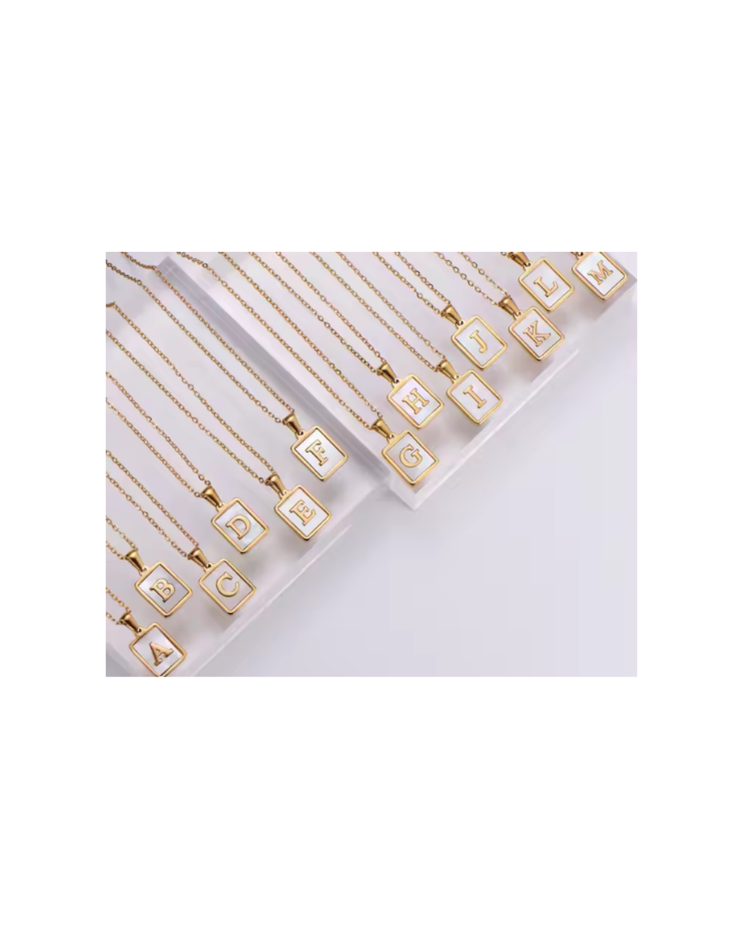 Gold initial letter charm necklaces with square pendants showing letters A, B, C, D and E