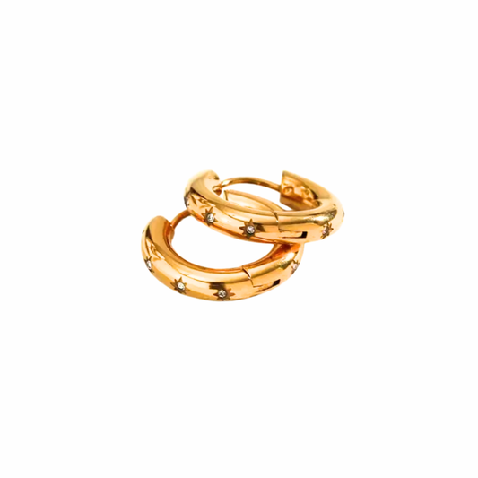 Serene gold huggie hoop earrings with star-set clear stones and polished dome finish