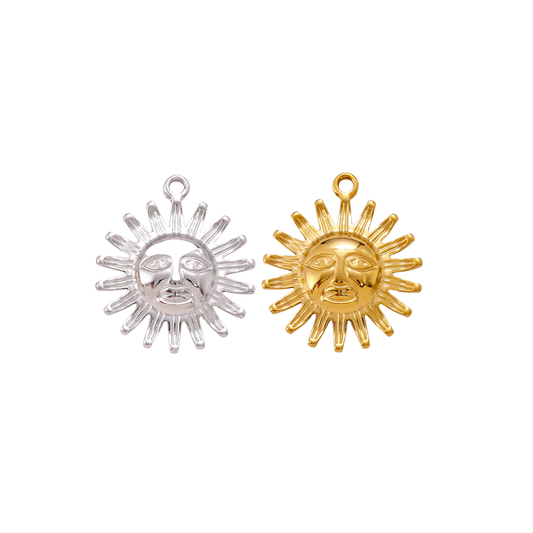 Gold and silver Solstice Sun Charm with celestial sun face design displayed side by side