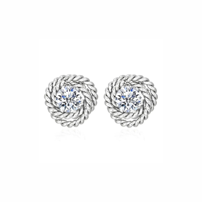 Pair of silver rope-style earrings with clear gemstones on a white background