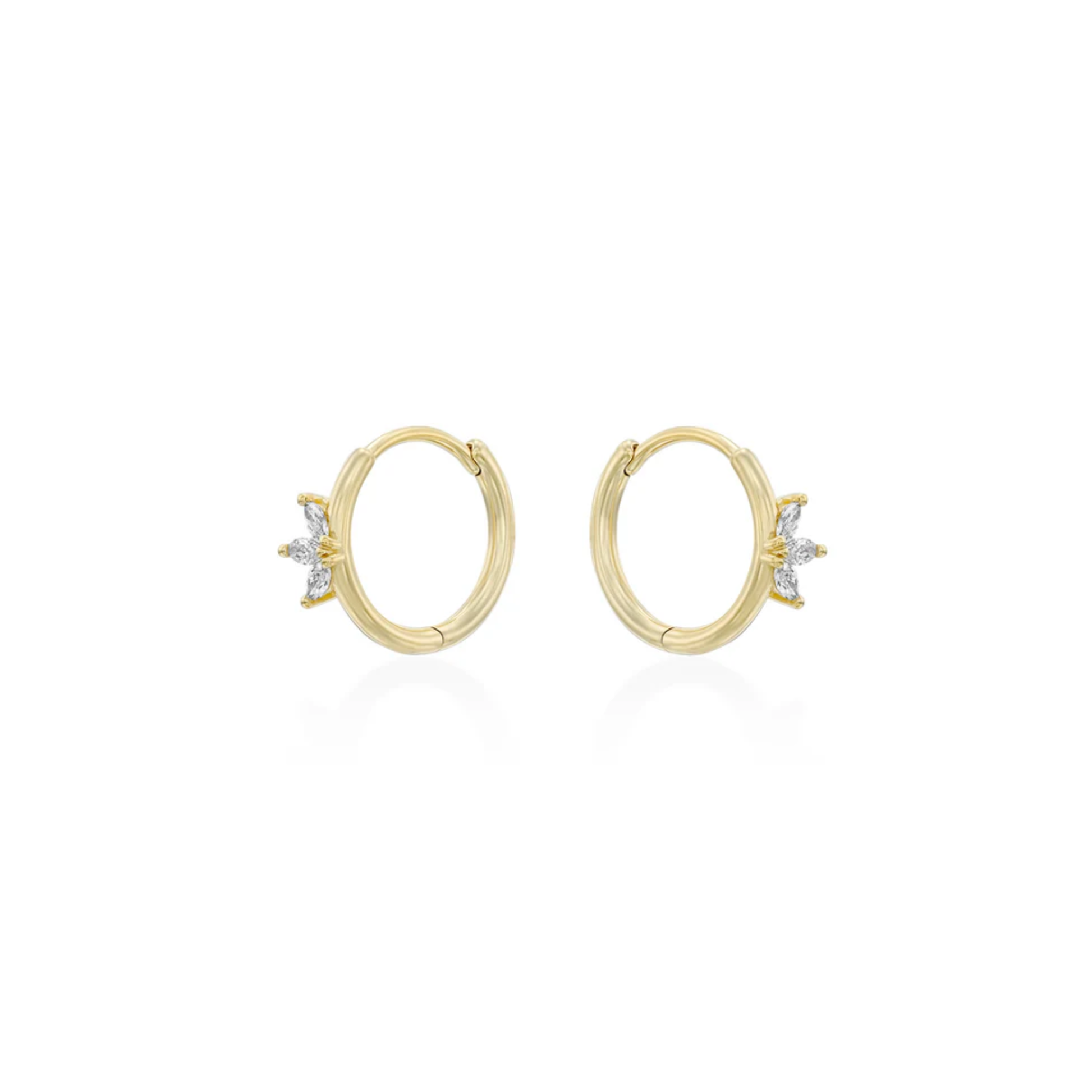 Gold crystal huggie earrings worn on ear, minimalist jewellery