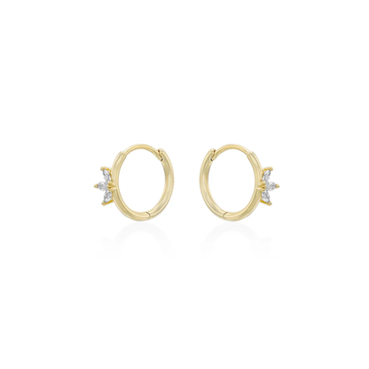 Gold crystal huggie earrings worn on ear, minimalist jewellery